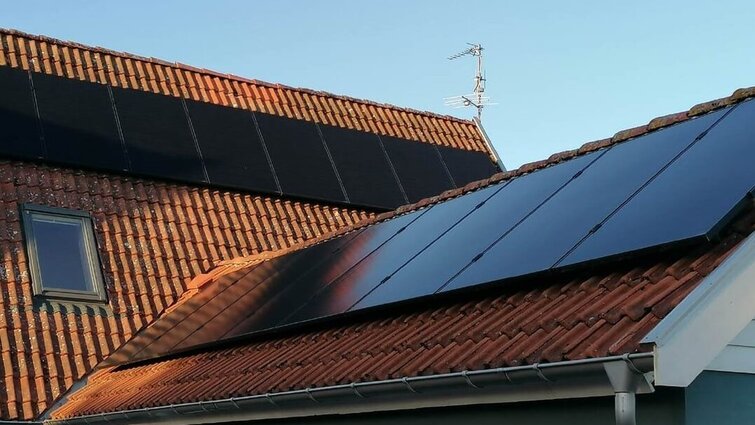 Rødt tag på hus med solceller