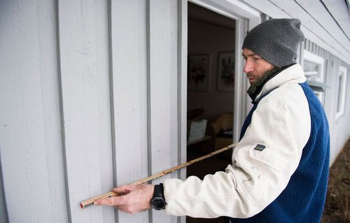 Ydervæg på hus måles med tommestok